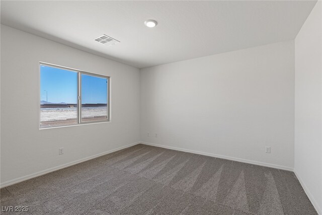 carpeted empty room with baseboards and visible vents