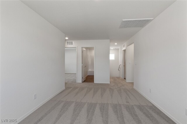 spare room with baseboards, carpet floors, visible vents, and recessed lighting