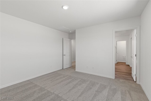 empty room featuring baseboards, visible vents, and carpet flooring