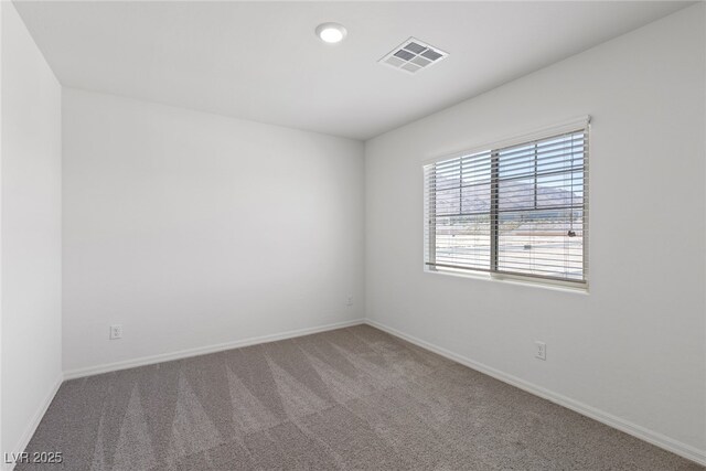 unfurnished room featuring baseboards, carpet floors, and visible vents