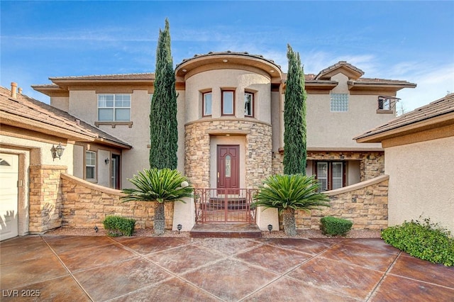 view of exterior entry with stone siding and stucco siding