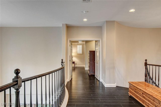 hallway featuring recessed lighting, baseboards, an upstairs landing, dark wood-type flooring, and visible vents
