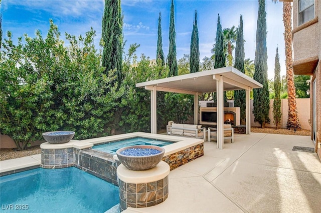 view of pool featuring a warm lit fireplace, a fenced backyard, a fenced in pool, an in ground hot tub, and a patio