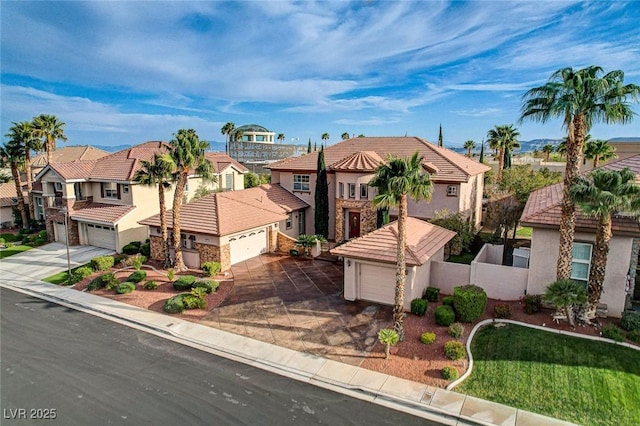 view of front of home with fence, a residential view, driveway, and stucco siding