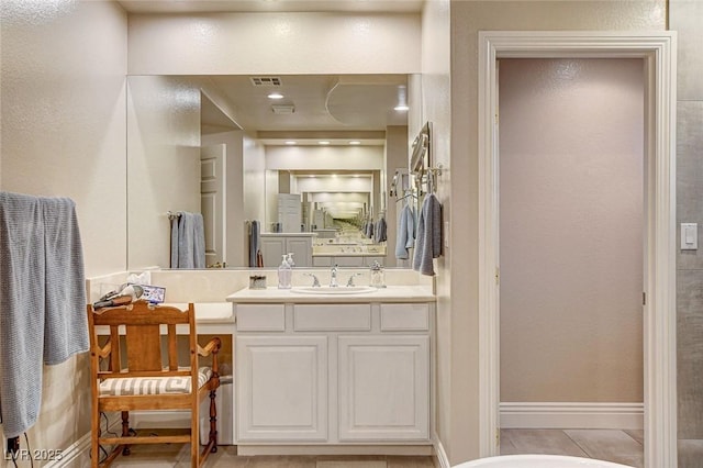 bathroom featuring vanity, baseboards, tile patterned flooring, and visible vents