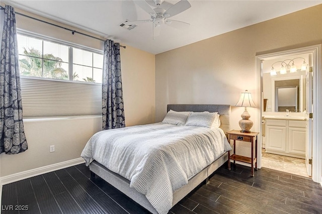 bedroom featuring baseboards, ensuite bathroom, dark wood-style floors, and visible vents
