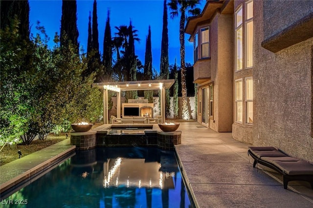view of pool with a patio, a pool with connected hot tub, and a pergola