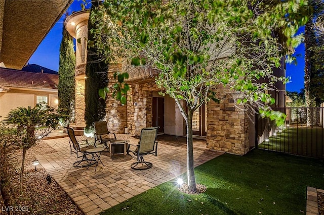 view of patio with fence and a fire pit