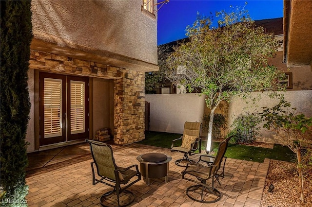 view of patio featuring fence and a fire pit