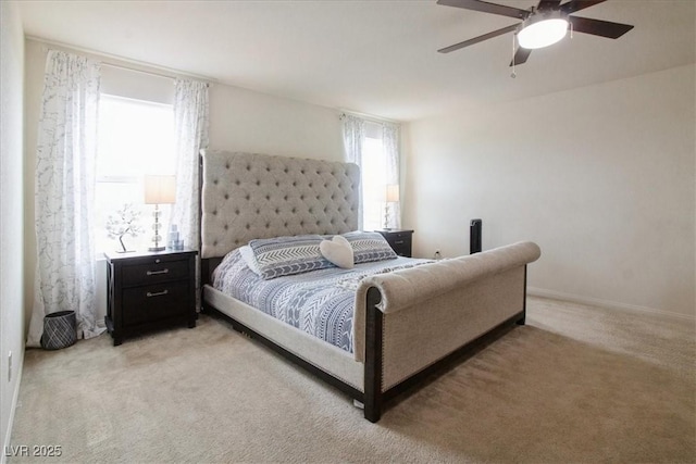 bedroom with light colored carpet and a ceiling fan