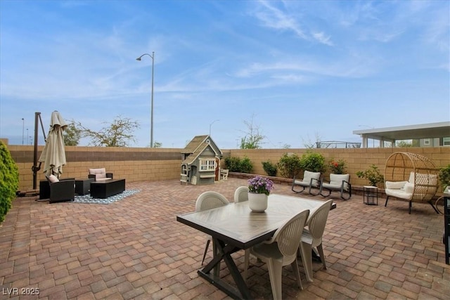 view of patio / terrace with outdoor lounge area, a fenced backyard, and outdoor dining space