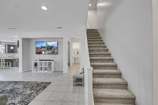 stairway with baseboards, tile patterned flooring, visible vents, and recessed lighting