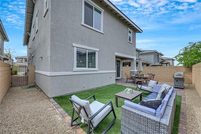 back of house featuring an outdoor living space, a patio, a fenced backyard, and stucco siding