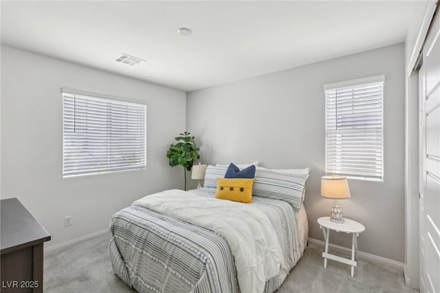carpeted bedroom featuring visible vents and baseboards