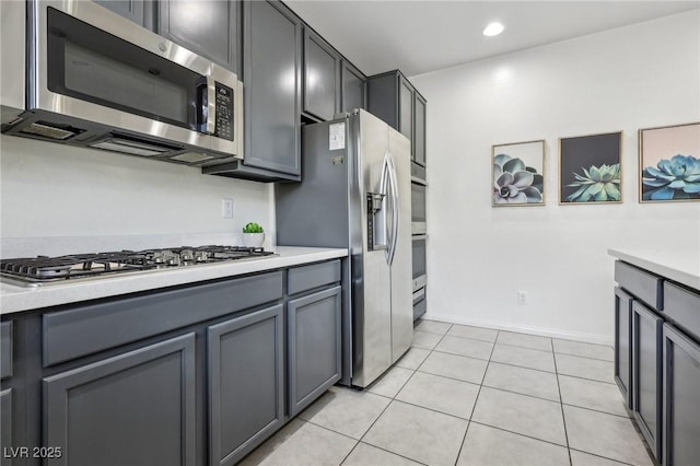 kitchen with light tile patterned floors, light countertops, and appliances with stainless steel finishes