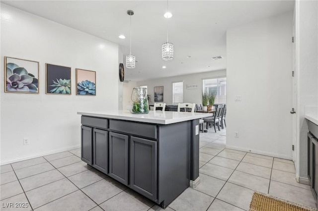 kitchen featuring recessed lighting, gray cabinetry, light tile patterned floors, and light countertops
