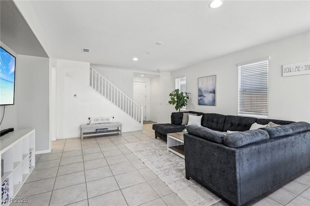living area featuring visible vents, light tile patterned floors, stairway, and recessed lighting