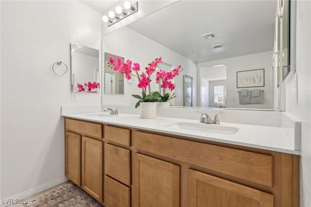 bathroom featuring a sink, visible vents, and double vanity