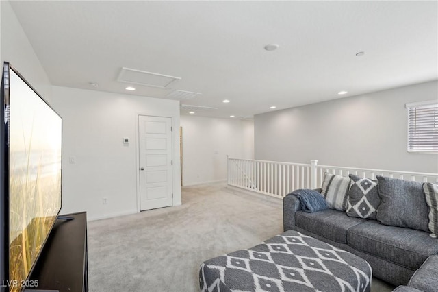 carpeted living room with baseboards, recessed lighting, and attic access