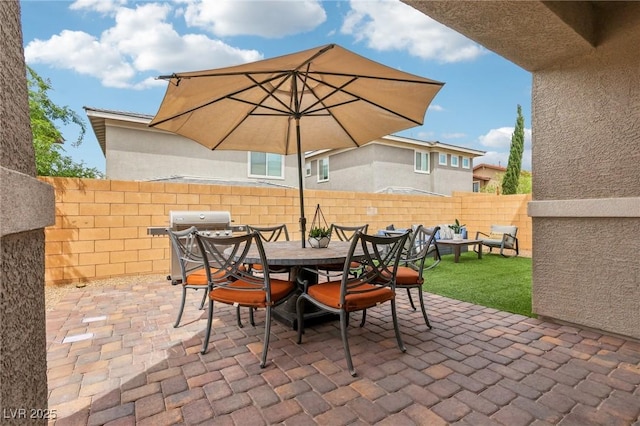 view of patio / terrace featuring area for grilling, outdoor dining space, and a fenced backyard