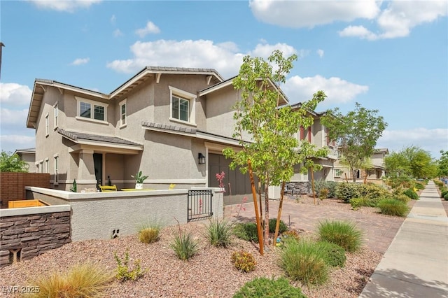 view of front of property featuring a fenced front yard and stucco siding