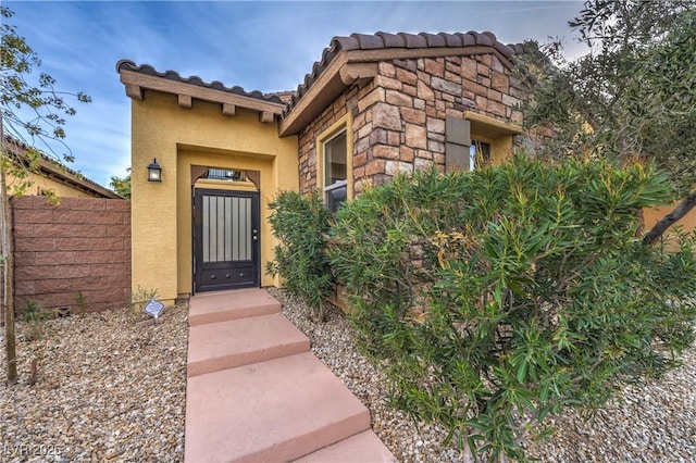 79 Rezzonico Dr, Henderson, NV 89011 - property entrance featuring stucco siding, a tile roof, and stone siding