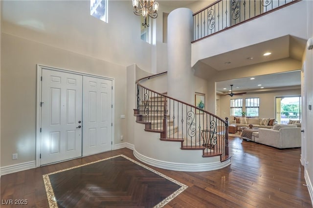 79 Rezzonico Dr, Henderson, NV 89011 - foyer entrance featuring baseboards, stairs, wood finished floors, ceiling fan, and a towering ceiling