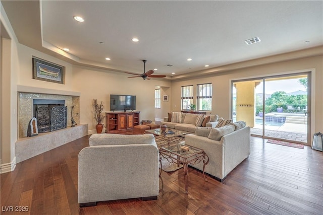 79 Rezzonico Dr, Henderson, NV 89011 - living area featuring dark wood finished floors, a ceiling fan, a high end fireplace, and recessed lighting
