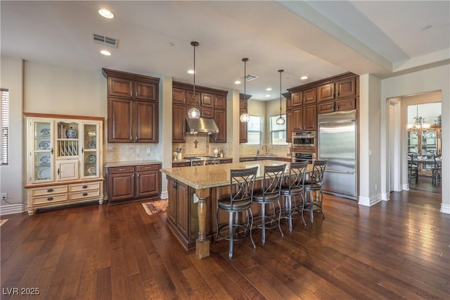 79 Rezzonico Dr, Henderson, NV 89011 - kitchen with built in fridge, dark wood-style floors, tasteful backsplash, under cabinet range hood, and recessed lighting