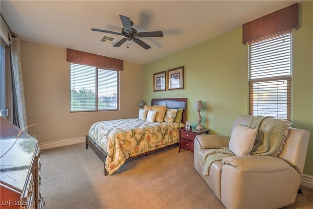 79 Rezzonico Dr, Henderson, NV 89011 - bedroom featuring multiple windows, light carpet, baseboards, and a ceiling fan
