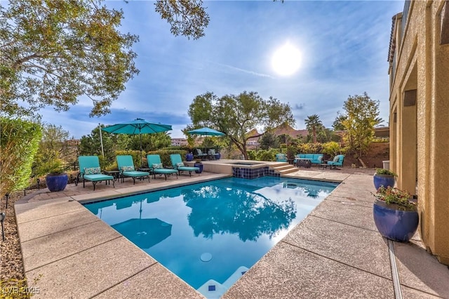 79 Rezzonico Dr, Henderson, NV 89011 - view of pool featuring a patio area, a pool with connected hot tub, and an outdoor hangout area