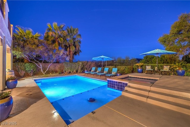 79 Rezzonico Dr, Henderson, NV 89011 - pool at night featuring an in-ground hot tub, a patio, and a fenced backyard