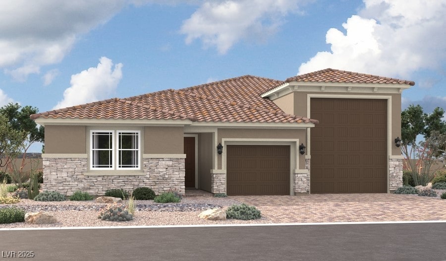 5745 E Badlands Ln, Pahrump, NV 89061 - mediterranean / spanish home featuring stone siding, a garage, stucco siding, and decorative driveway