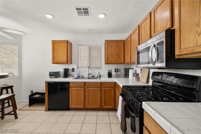 388 Coronado Dr, Henderson, NV 89015 - kitchen featuring black appliances, a sink, tile counters, brown cabinets, and recessed lighting