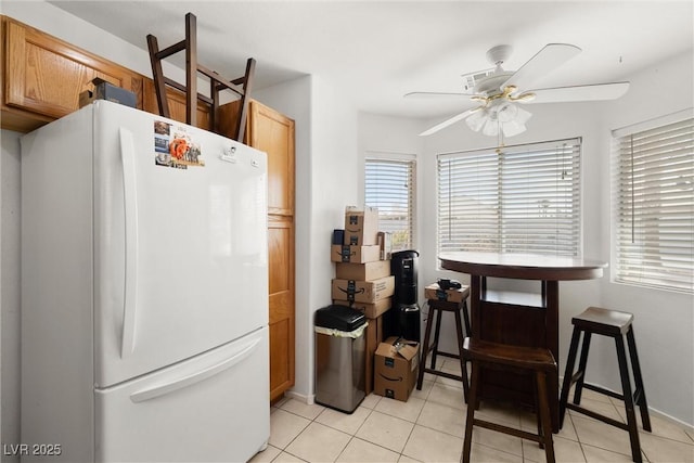 388 Coronado Dr, Henderson, NV 89015 - kitchen with freestanding refrigerator, ceiling fan, light tile patterned flooring, and baseboards
