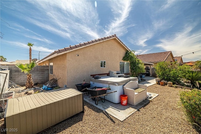 388 Coronado Dr, Henderson, NV 89015 - back of property featuring stucco siding, a hot tub, a patio area, and a tiled roof