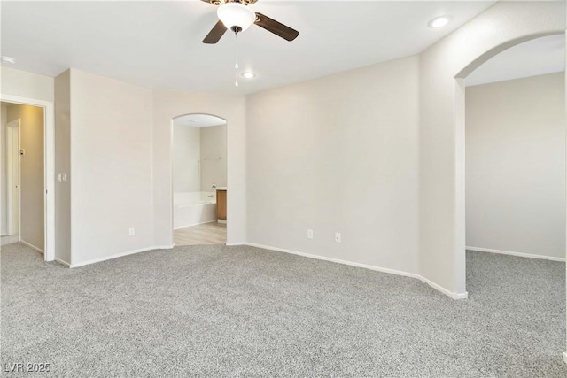 7486 River Dove Ct, Las Vegas, NV 89139 - unfurnished room featuring arched walkways, carpet flooring, a ceiling fan, and recessed lighting