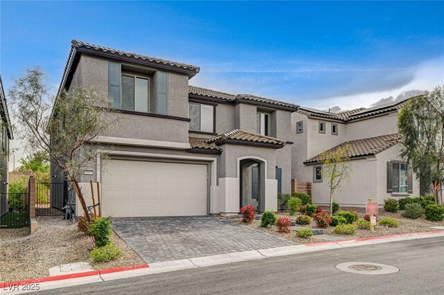 9993 Birch Knoll Ave, Las Vegas, NV 89166 - view of front of house featuring a garage, a tile roof, stucco siding, and decorative driveway