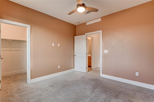 9993 Birch Knoll Ave, Las Vegas, NV 89166 - unfurnished bedroom featuring light carpet, a walk in closet, and baseboards