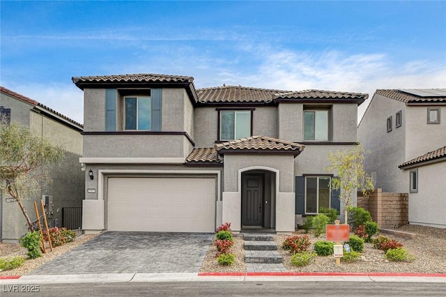 9993 Birch Knoll Ave, Las Vegas, NV 89166 - mediterranean / spanish-style home featuring an attached garage, a tile roof, stucco siding, and decorative driveway
