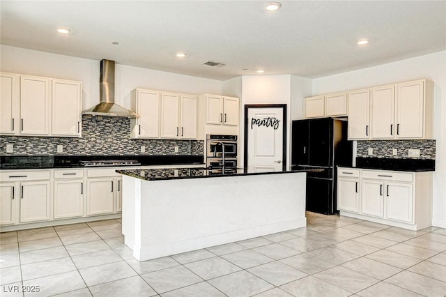 9993 Birch Knoll Ave, Las Vegas, NV 89166 - kitchen with wall chimney exhaust hood, appliances with stainless steel finishes, dark countertops, tasteful backsplash, and a kitchen island with sink