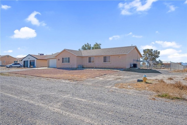 2831 Goldrush St, Pahrump, NV 89048 - ranch-style house featuring stucco siding, fence, driveway, a garage, and central AC