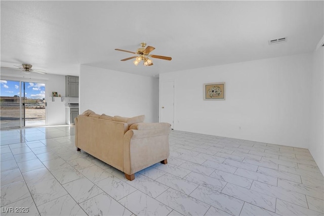 2831 Goldrush St, Pahrump, NV 89048 - living room with marble finish floor, visible vents, and ceiling fan