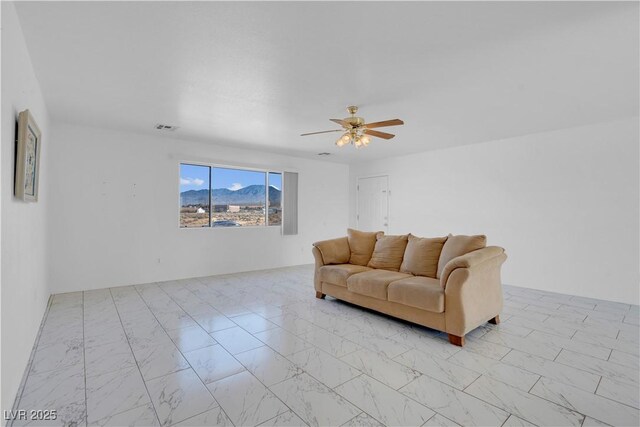 2831 Goldrush St, Pahrump, NV 89048 - living room featuring marble finish floor, visible vents, and a ceiling fan