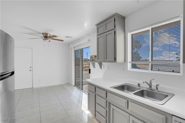 2831 Goldrush St, Pahrump, NV 89048 - kitchen featuring light countertops, a ceiling fan, a sink, gray cabinets, and freestanding refrigerator