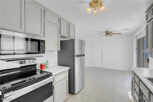 2831 Goldrush St, Pahrump, NV 89048 - kitchen featuring gray cabinets, light countertops, a ceiling fan, appliances with stainless steel finishes, and light tile patterned floors