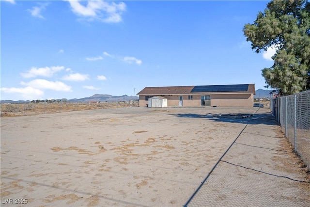 2831 Goldrush St, Pahrump, NV 89048 - view of yard with a shed, an outbuilding, fence, and a mountain view