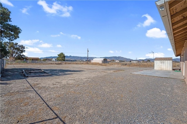 2831 Goldrush St, Pahrump, NV 89048 - view of yard with an outbuilding, a shed, and a mountain view