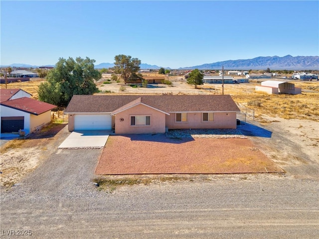 2831 Goldrush St, Pahrump, NV 89048 - single story home featuring driveway, stucco siding, a garage, and a mountain view
