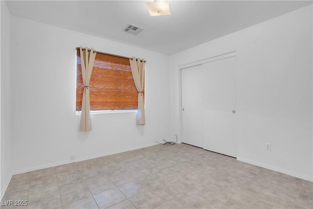 2831 Goldrush St, Pahrump, NV 89048 - unfurnished bedroom featuring baseboards, visible vents, and a closet